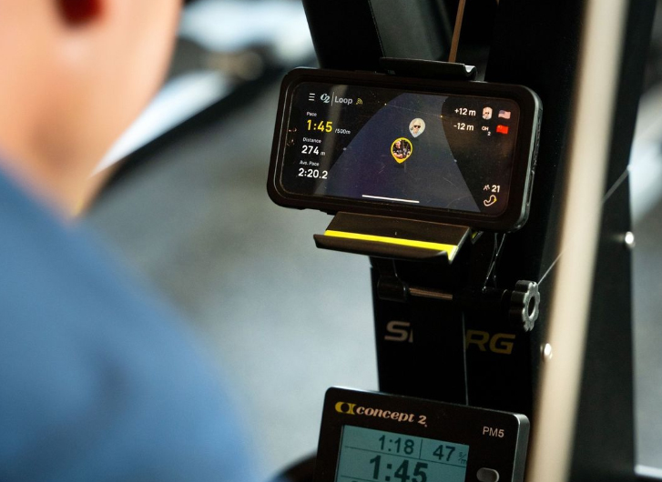 Person using the SkiErg with a smartphone showing the Real Time Loop
